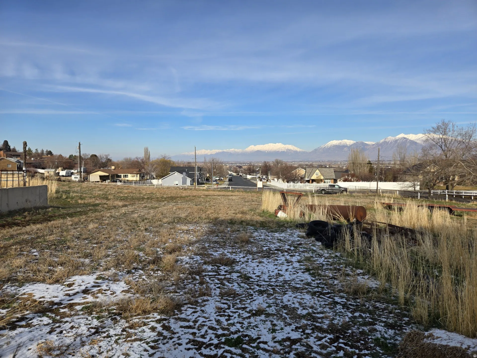 Yard covered in snow with a mountain view