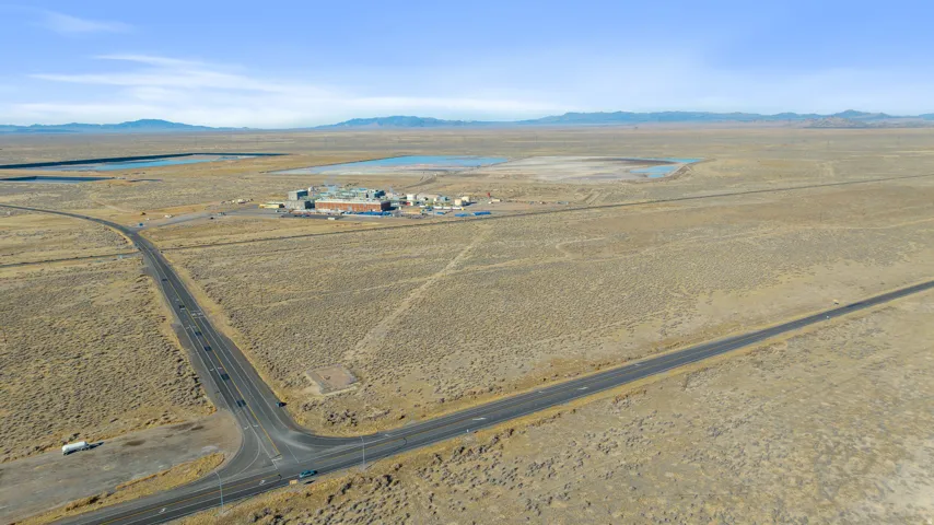 Aerial view of property and surrounding area featuring rural landscape and mountains