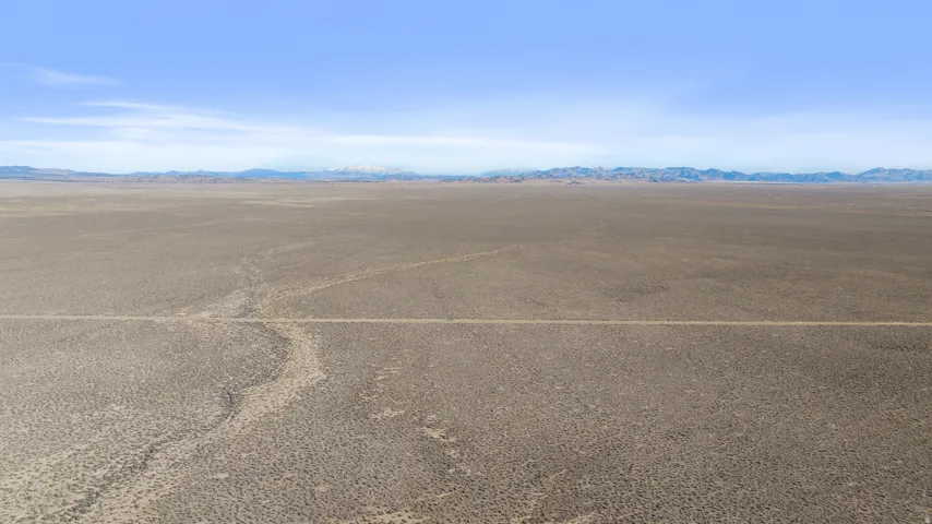 View of vehicle parking with a rural view, a mountain view, and view of desert