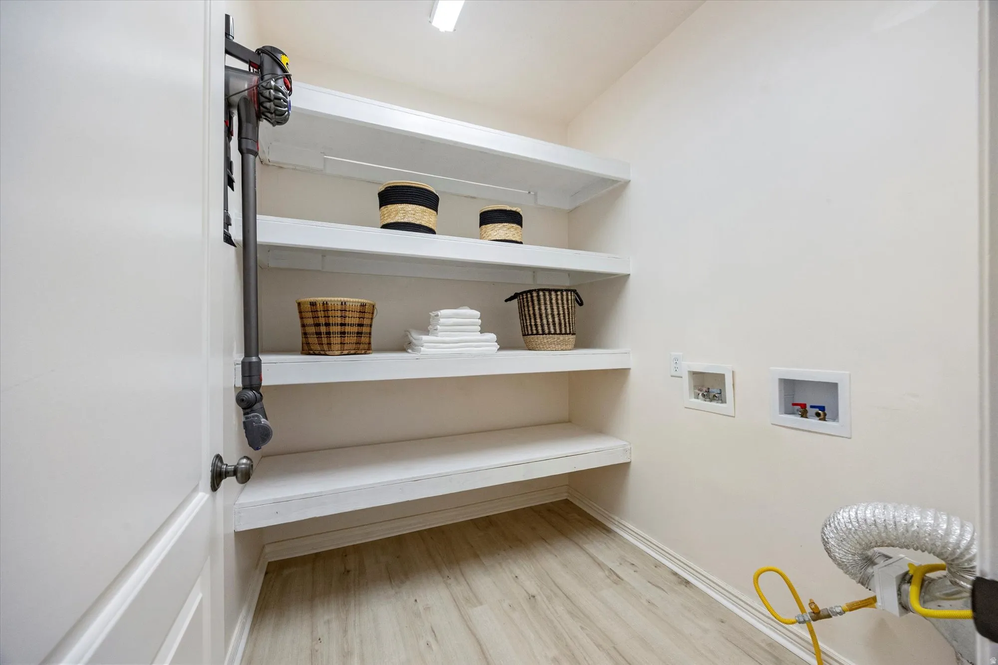 Laundry room with washer hookup and light wood finished floors