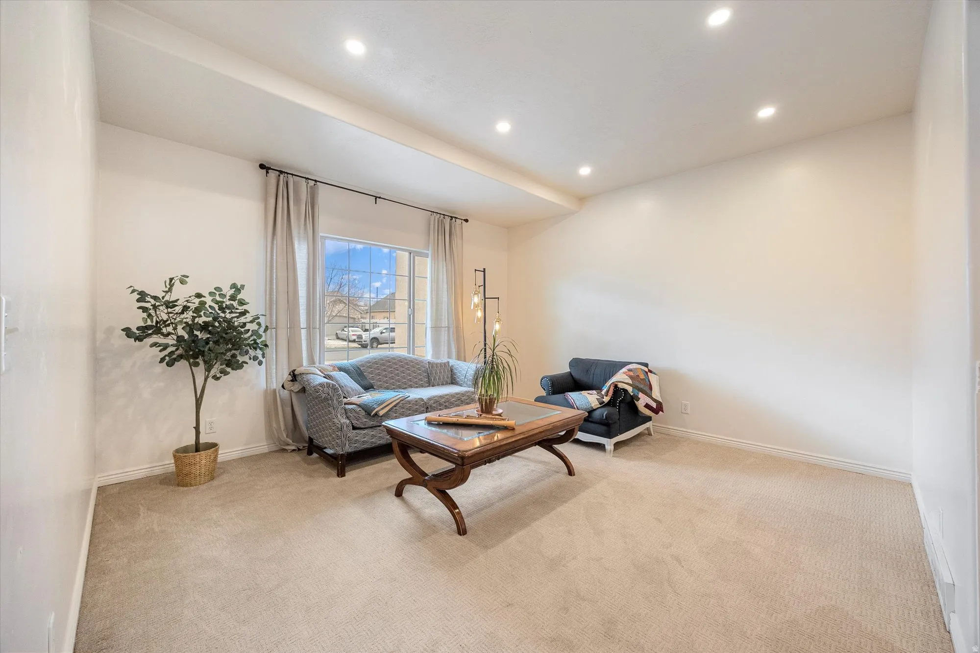 Living area with carpet flooring and recessed lighting