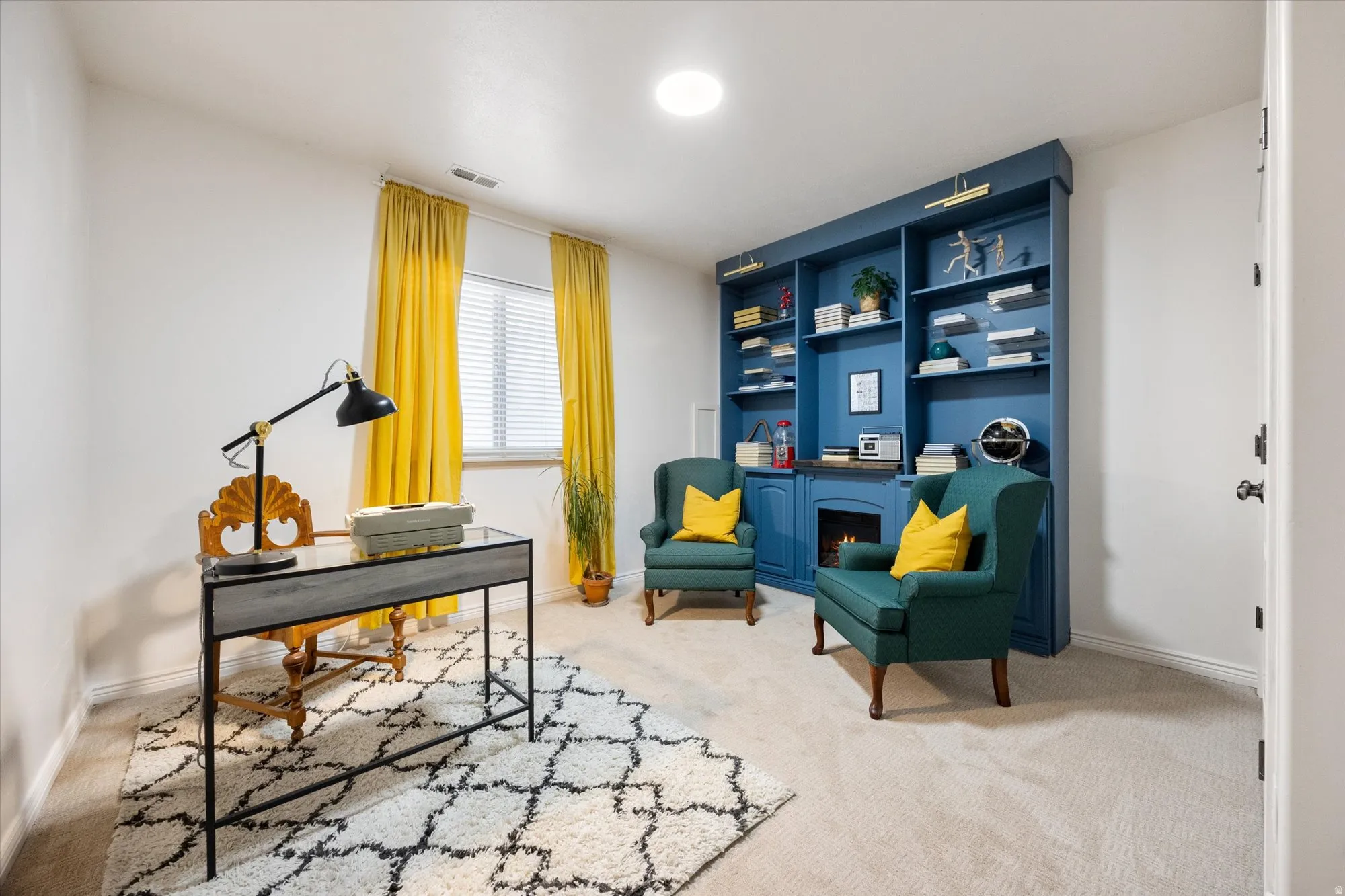 Carpeted office space with baseboards