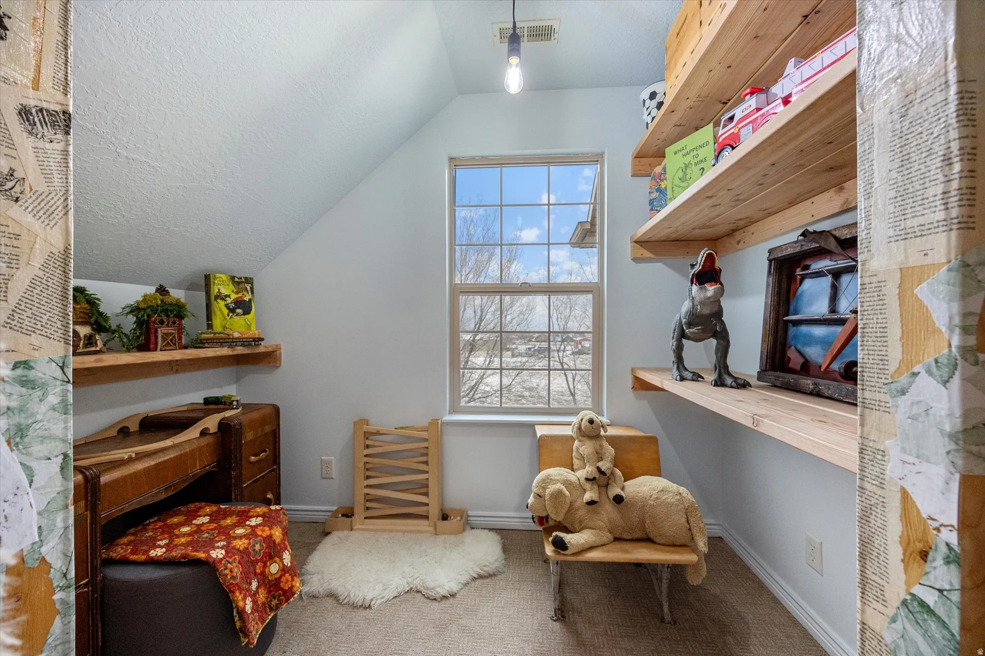 Home office featuring vaulted ceiling, carpet floors, and a textured ceiling