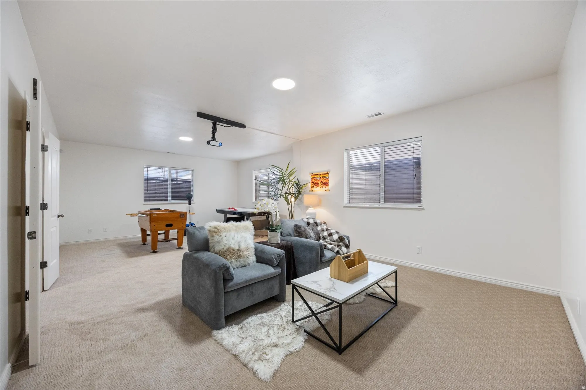 Living room featuring light colored carpet and recessed lighting