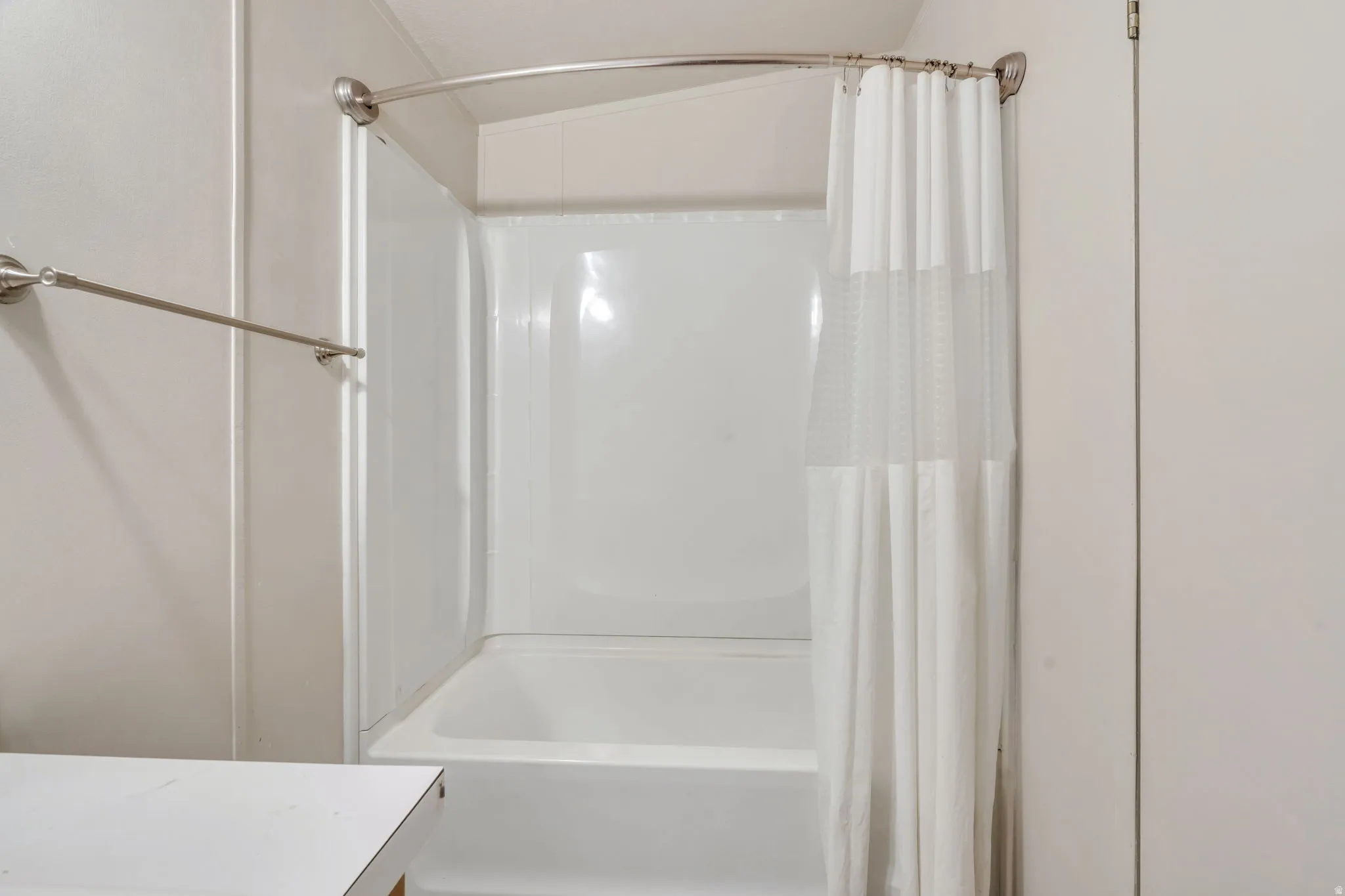 Bathroom with shower / bath combo with shower curtain and vanity