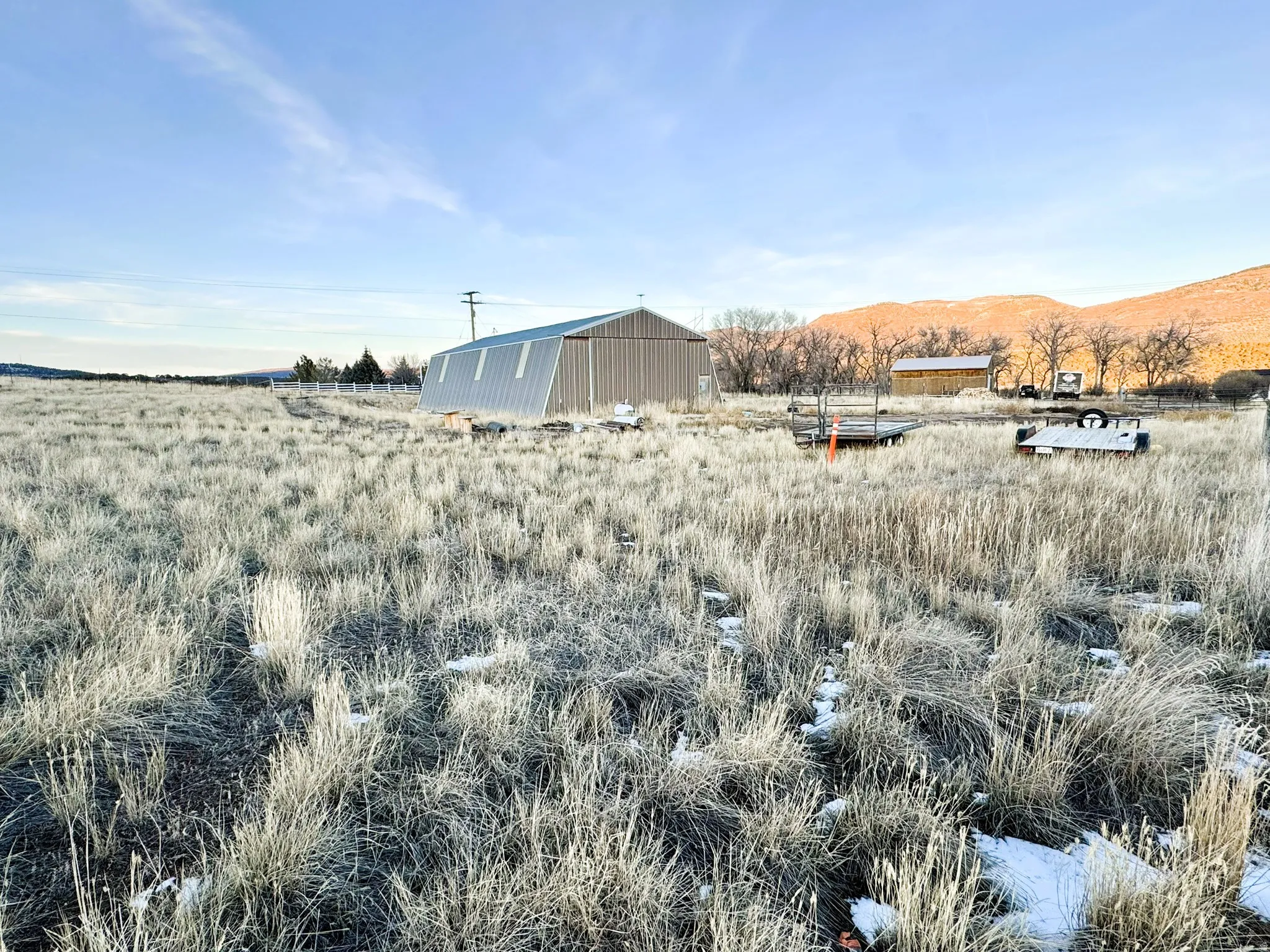 View of yard featuring a rural view, an outbuilding, and a pole building