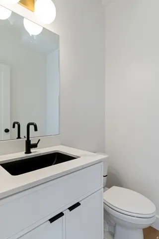 Half bathroom with vanity and toilet
