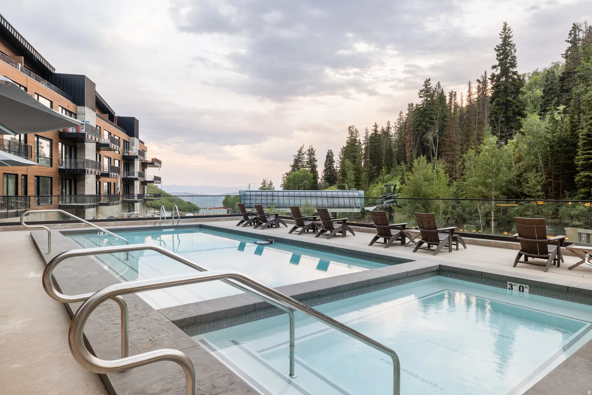Community pool featuring a patio and a hot tub