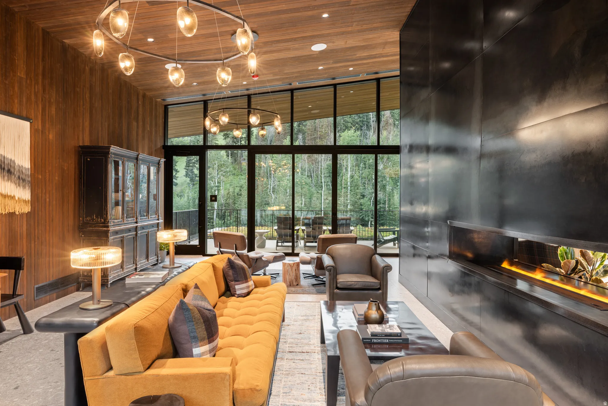 Community lobby featuring wooden walls, floor to ceiling windows, wood ceiling, and a high ceiling