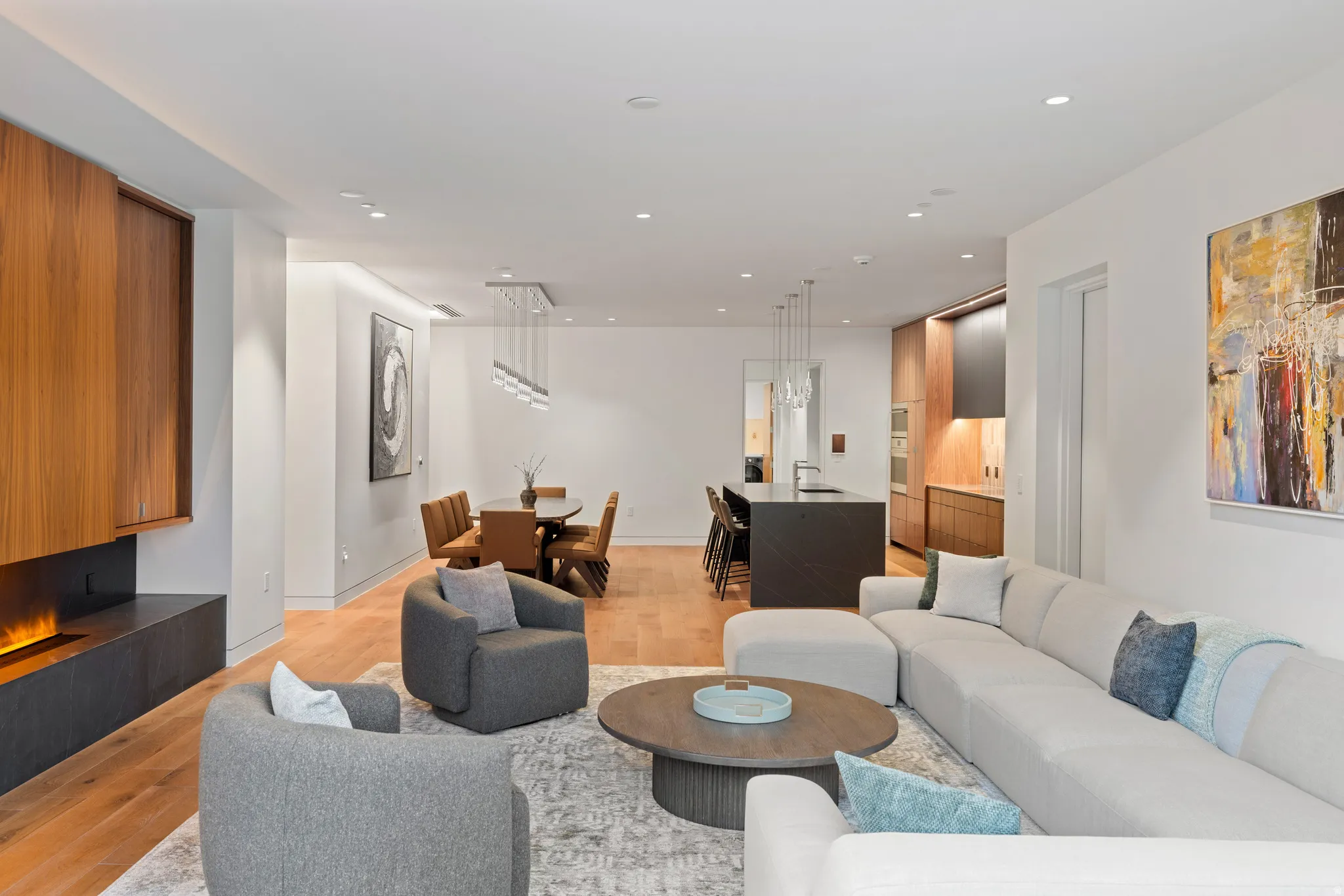 Living room with light wood-type flooring and recessed lighting