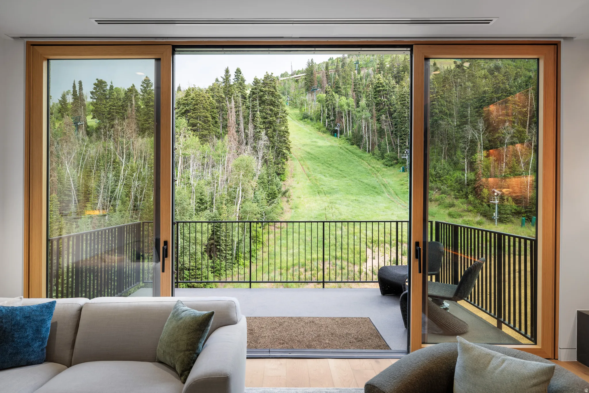 Entryway featuring wood finished floors, view of wooded area, and plenty of natural light