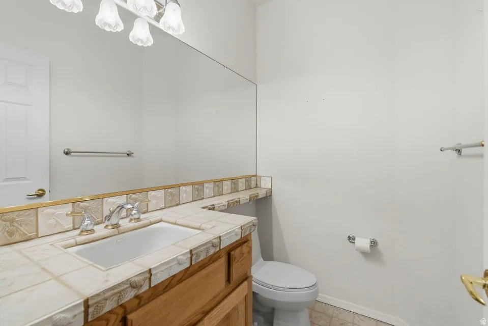 Bathroom featuring vanity and baseboards