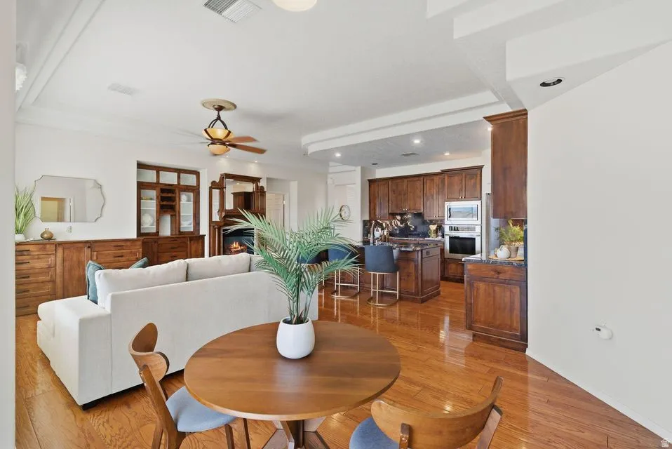 Dining room featuring ceiling fan, light wood-style floors, and recessed lighting