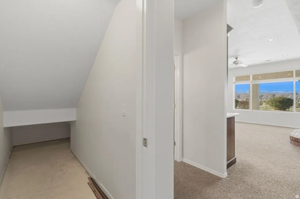 Hall featuring light colored carpet