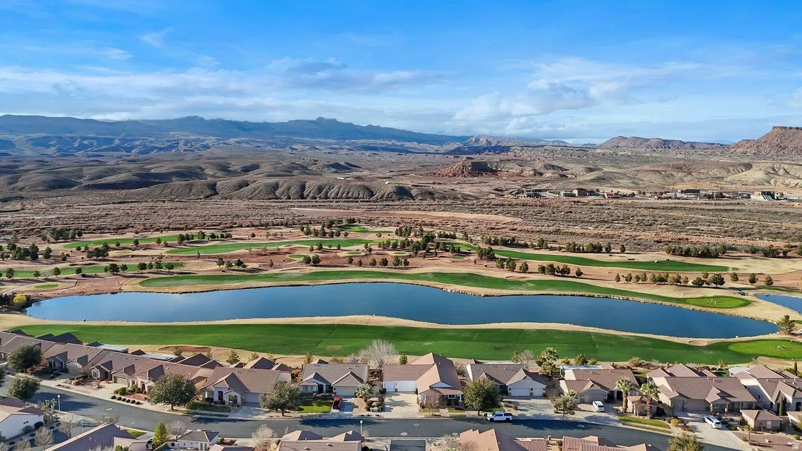 Aerial perspective of suburban area featuring a water and mountain view and a golf course