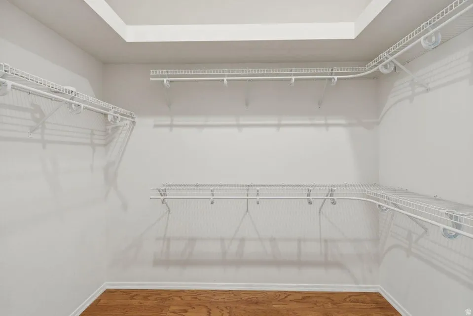 Walk in closet featuring wood finished floors