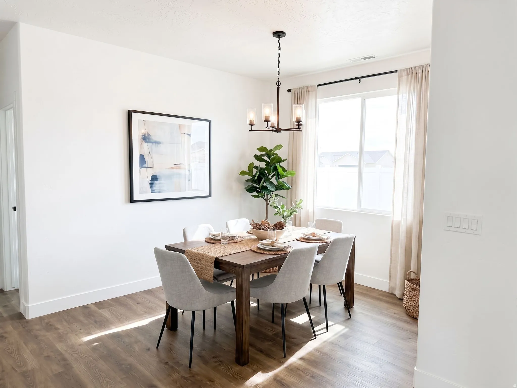 Ai Staged. Wood-finish flooring, white walls, and a multi-pane window with a dark curtain rod