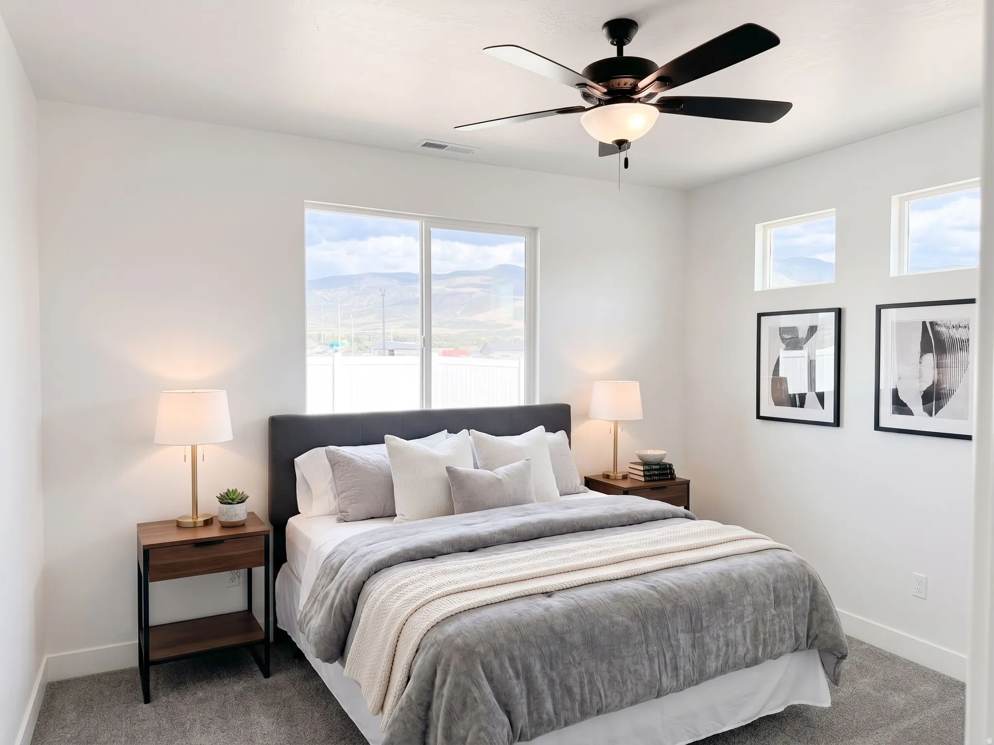 Ai Staged. Plush carpeting, a ceiling fan with integrated lighting, and multiple windows providing natural light