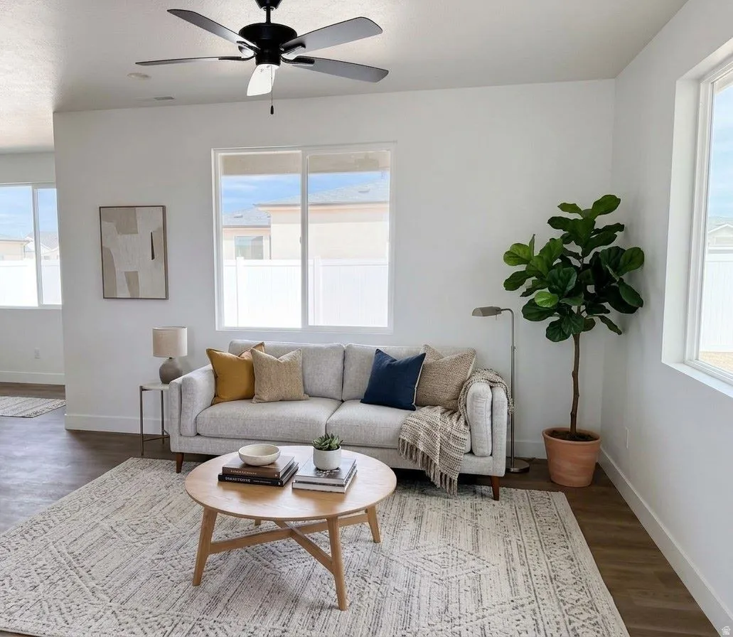 Ai Staged. Recessed lighting, wood-finish flooring, white walls, multiple windows, and a ceiling fan