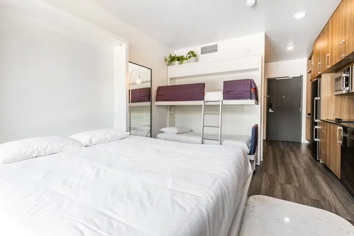 Bedroom featuring dark wood-style floors and high quality fridge