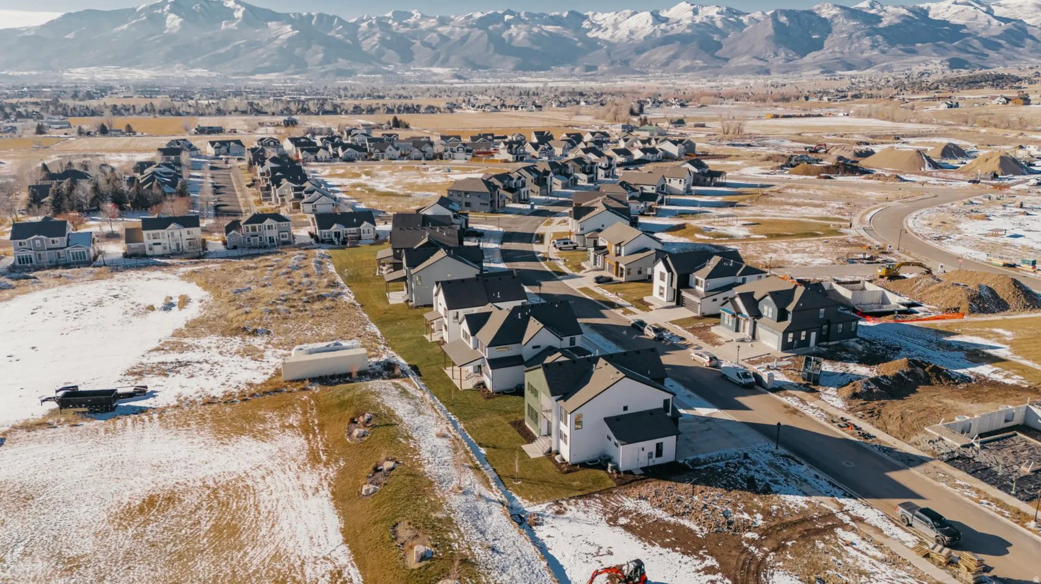 Snowy aerial view with a mountain view and a residential view