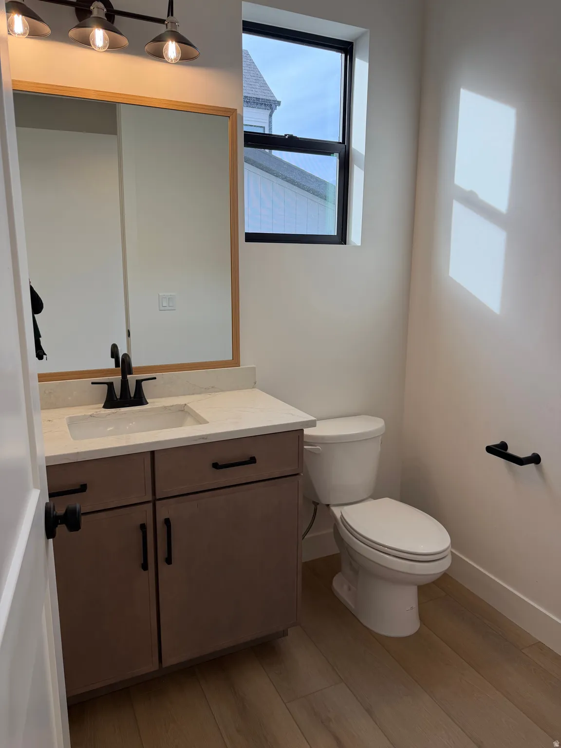 Bathroom with vanity and light wood-style floors
