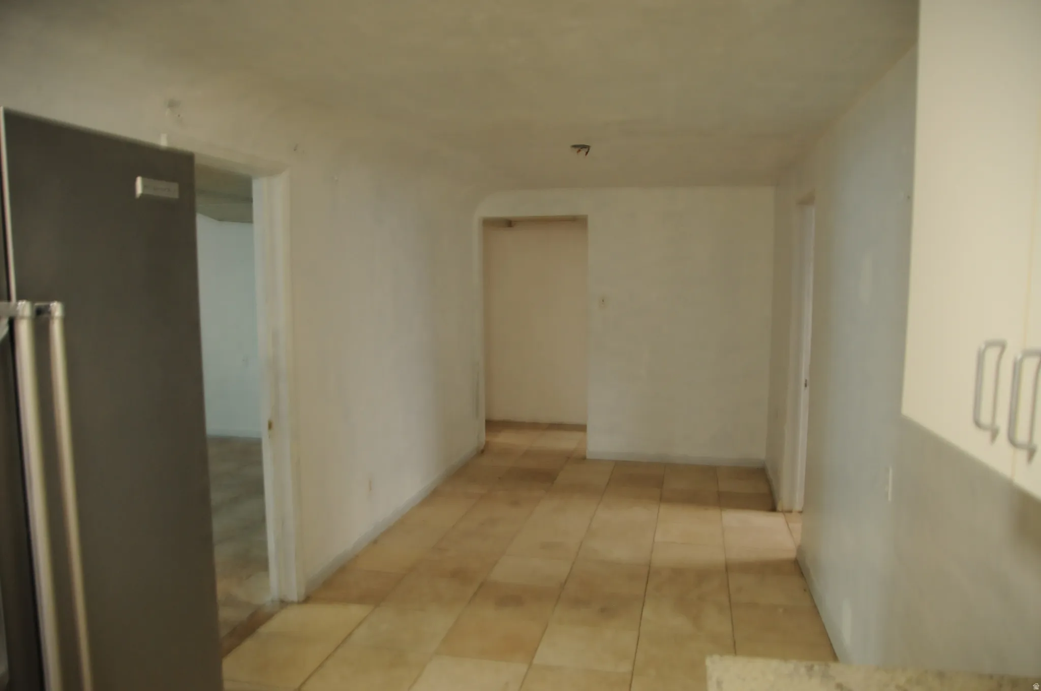Hall with light tile patterned floors