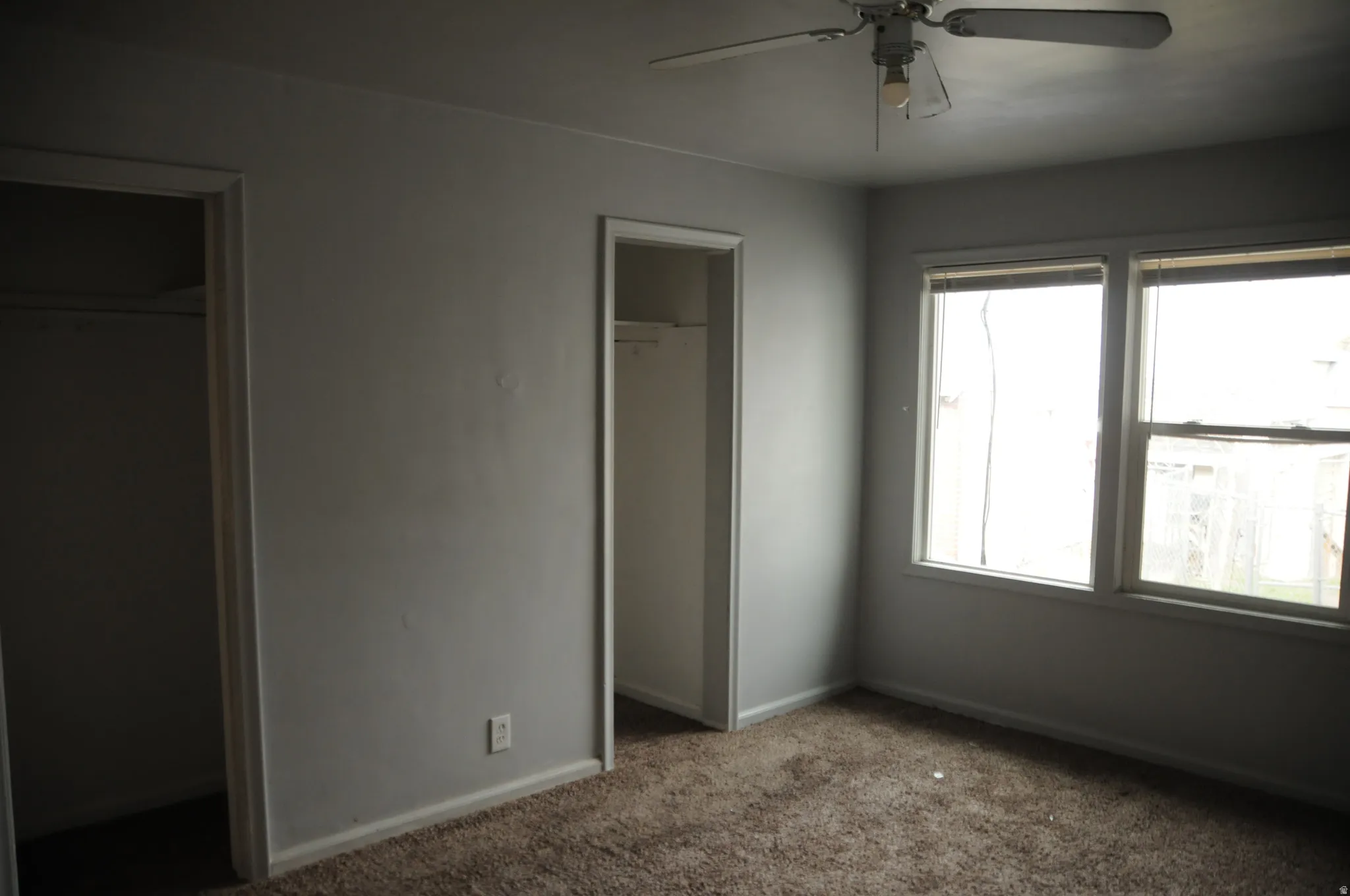 Unfurnished bedroom featuring carpet and ceiling fan