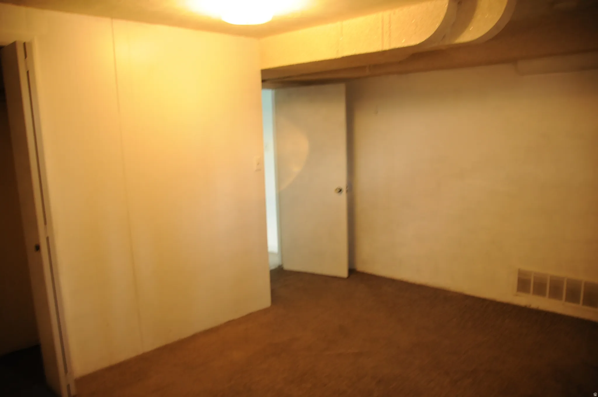 Unfurnished bedroom featuring a closet and carpet floors