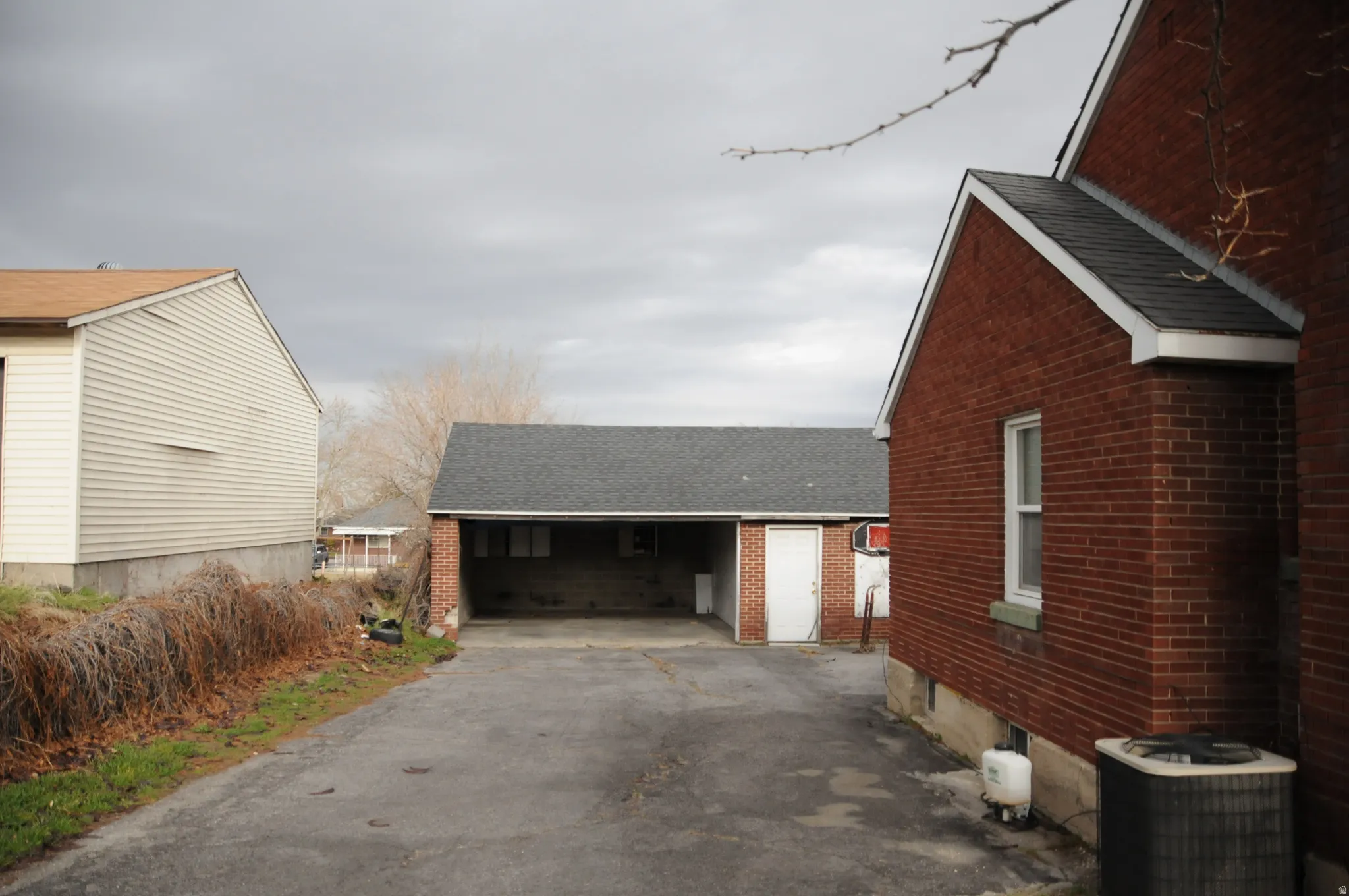 View of home's exterior featuring roof with shingles and brick siding