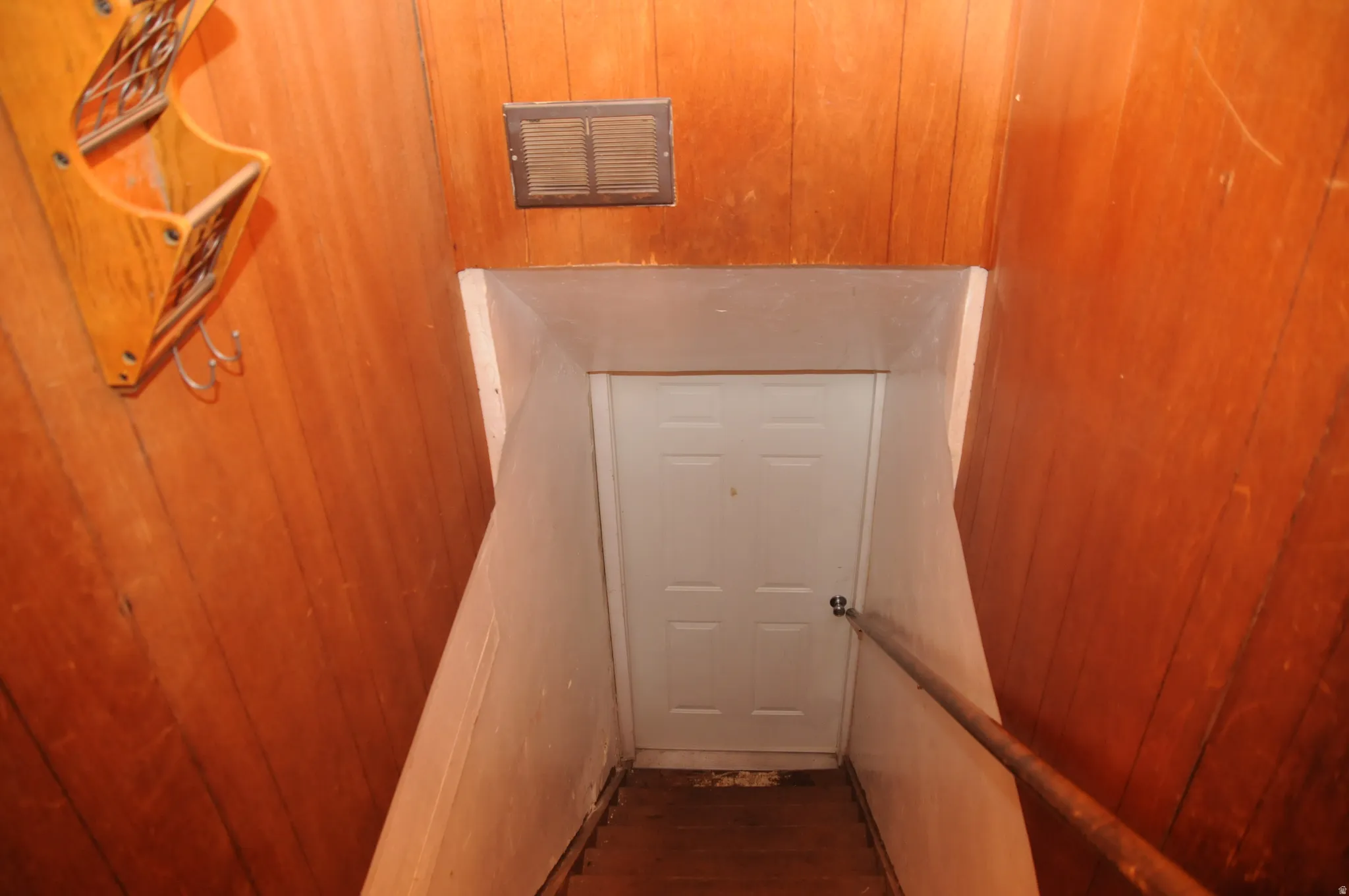 Stairway with wooden walls and wood finished floors