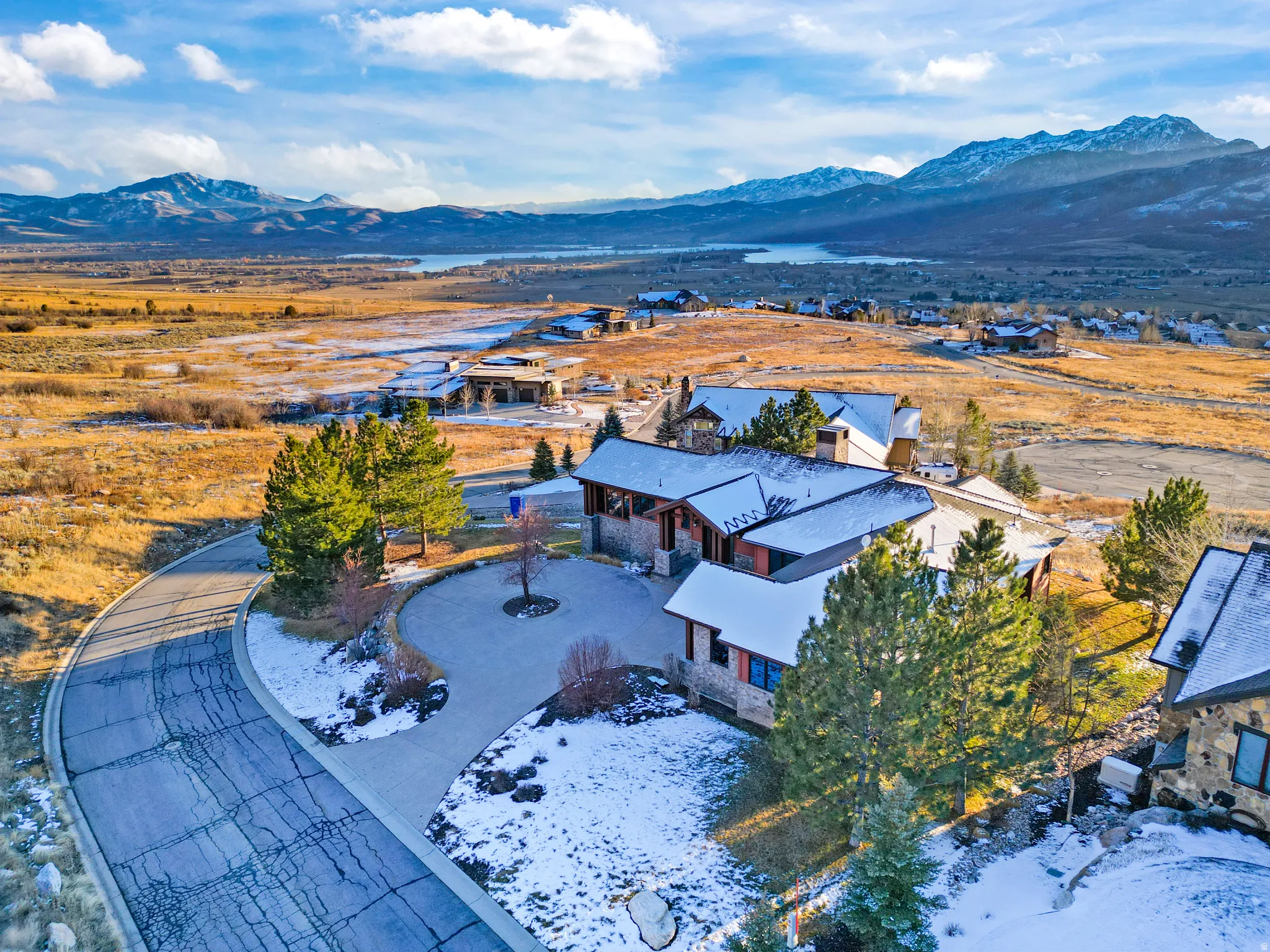 Snowy aerial view featuring a mountain view and a residential view