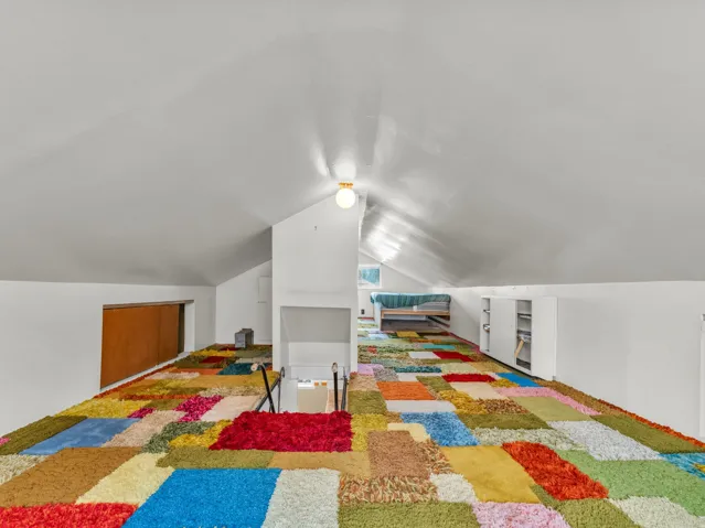 Bedroom featuring lofted ceiling