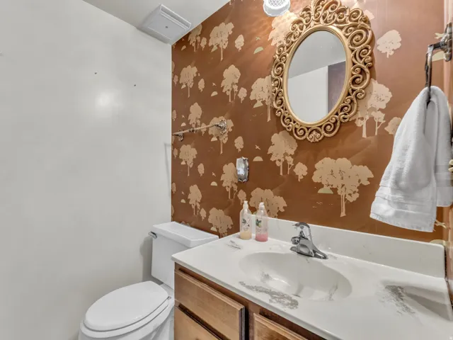 Half bathroom featuring vanity and toilet