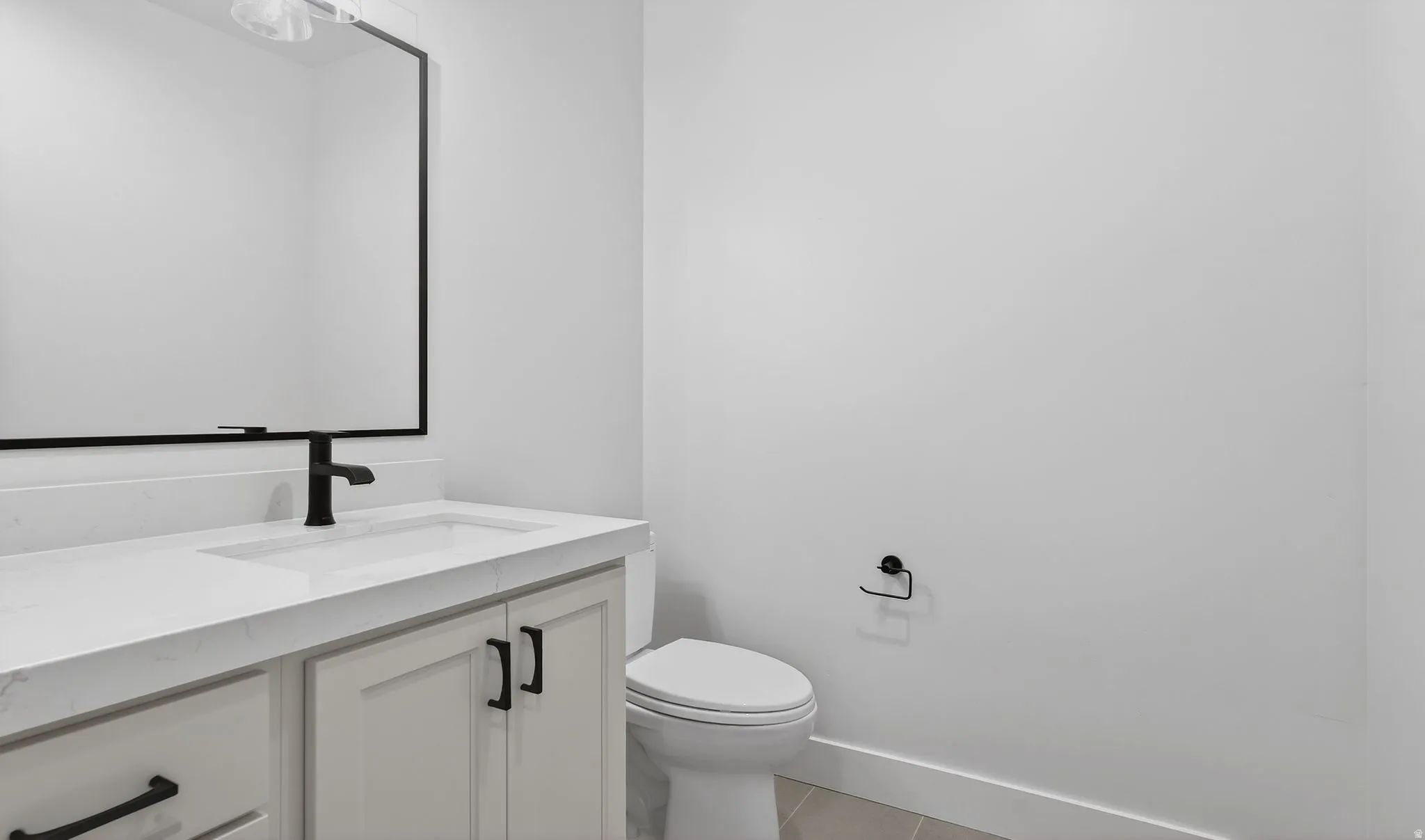 powder Half bath with vanity and light tile patterned flooring