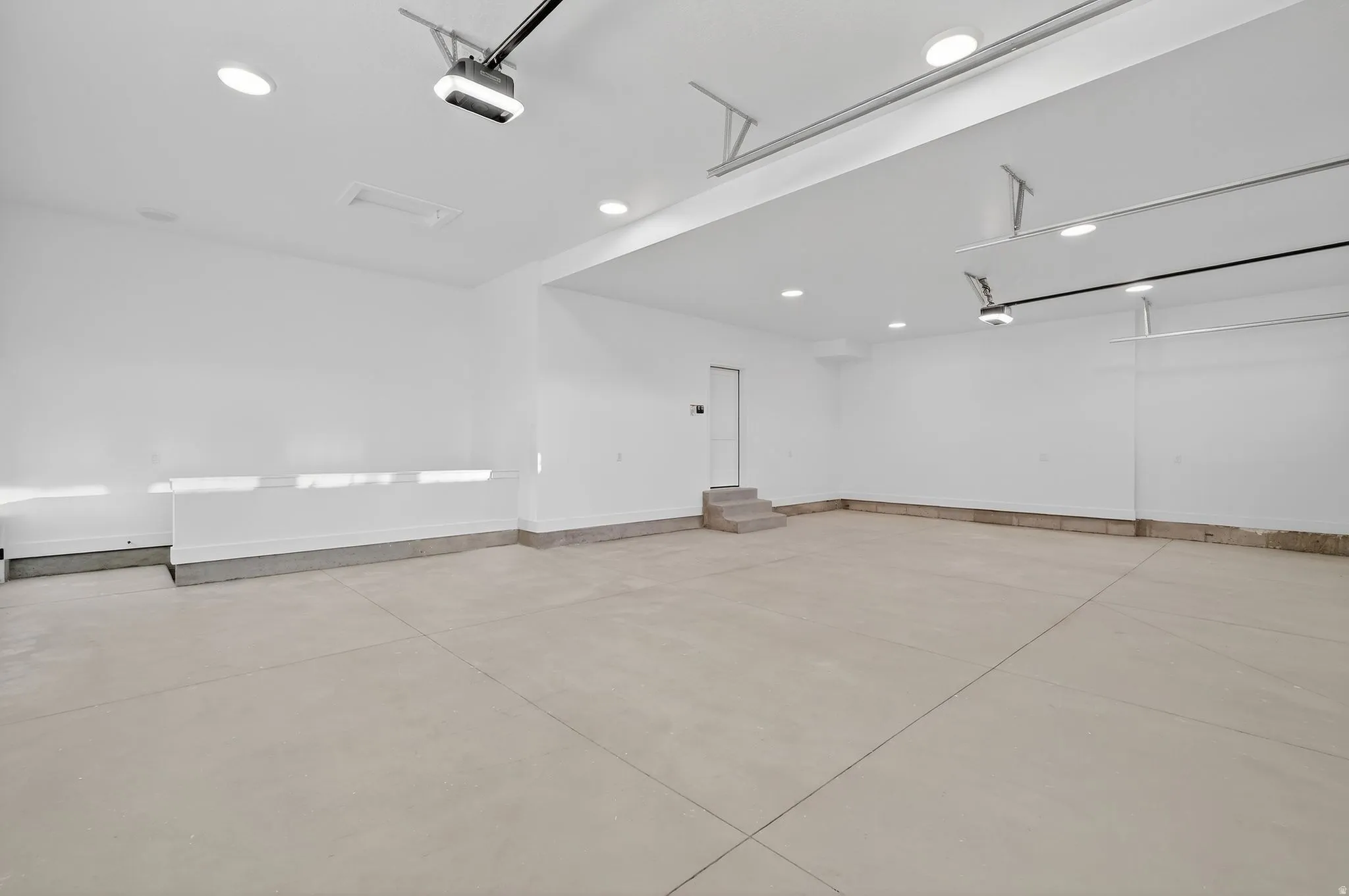 Finished and painted Garage space featuring recessed lighting and a garage door opener 13' garage door height extra  long, tall and wide, upgraded and undulated doors.
