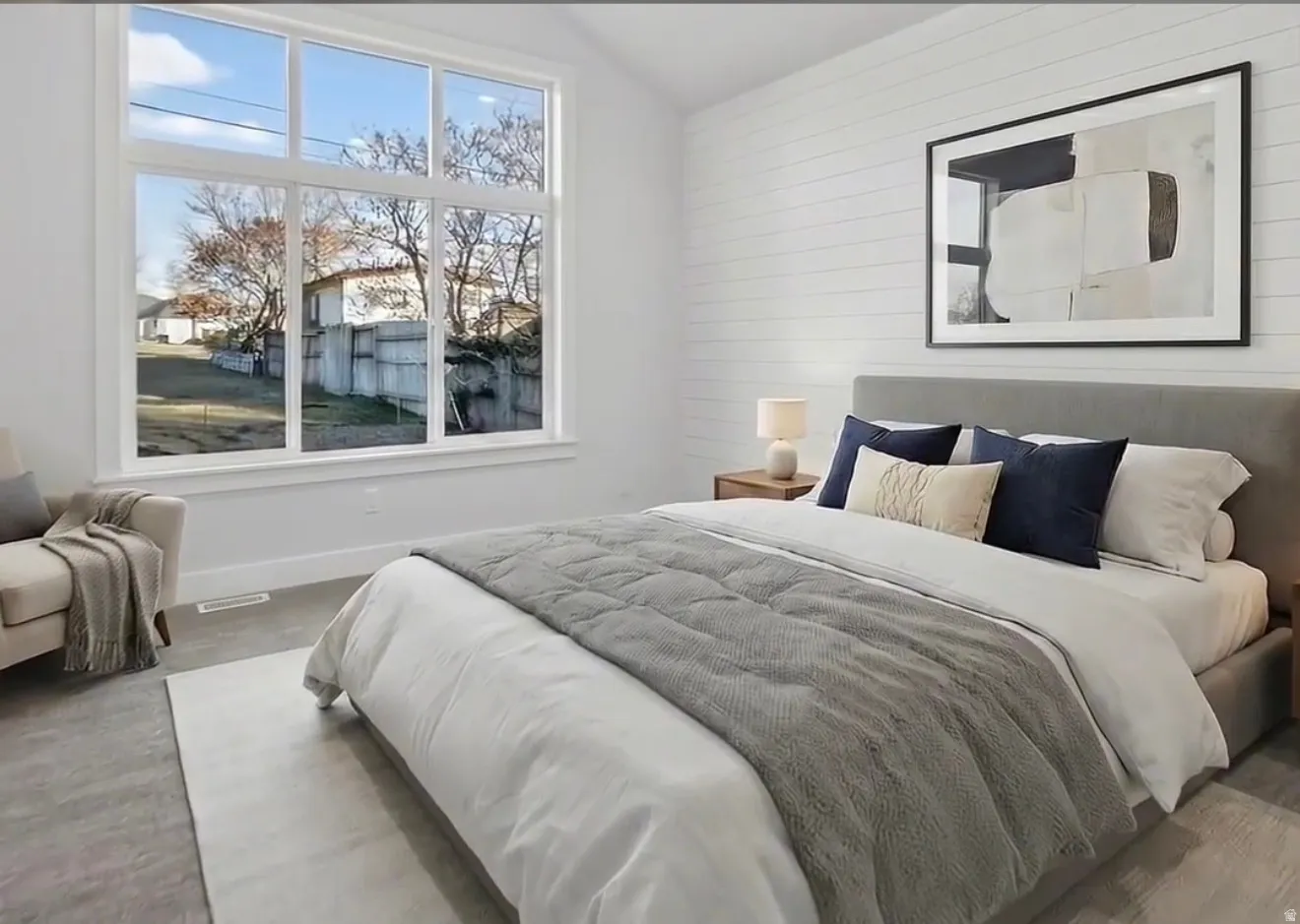Virtually staged primary suite Bedroom with vaulted ceiling and wooden walls