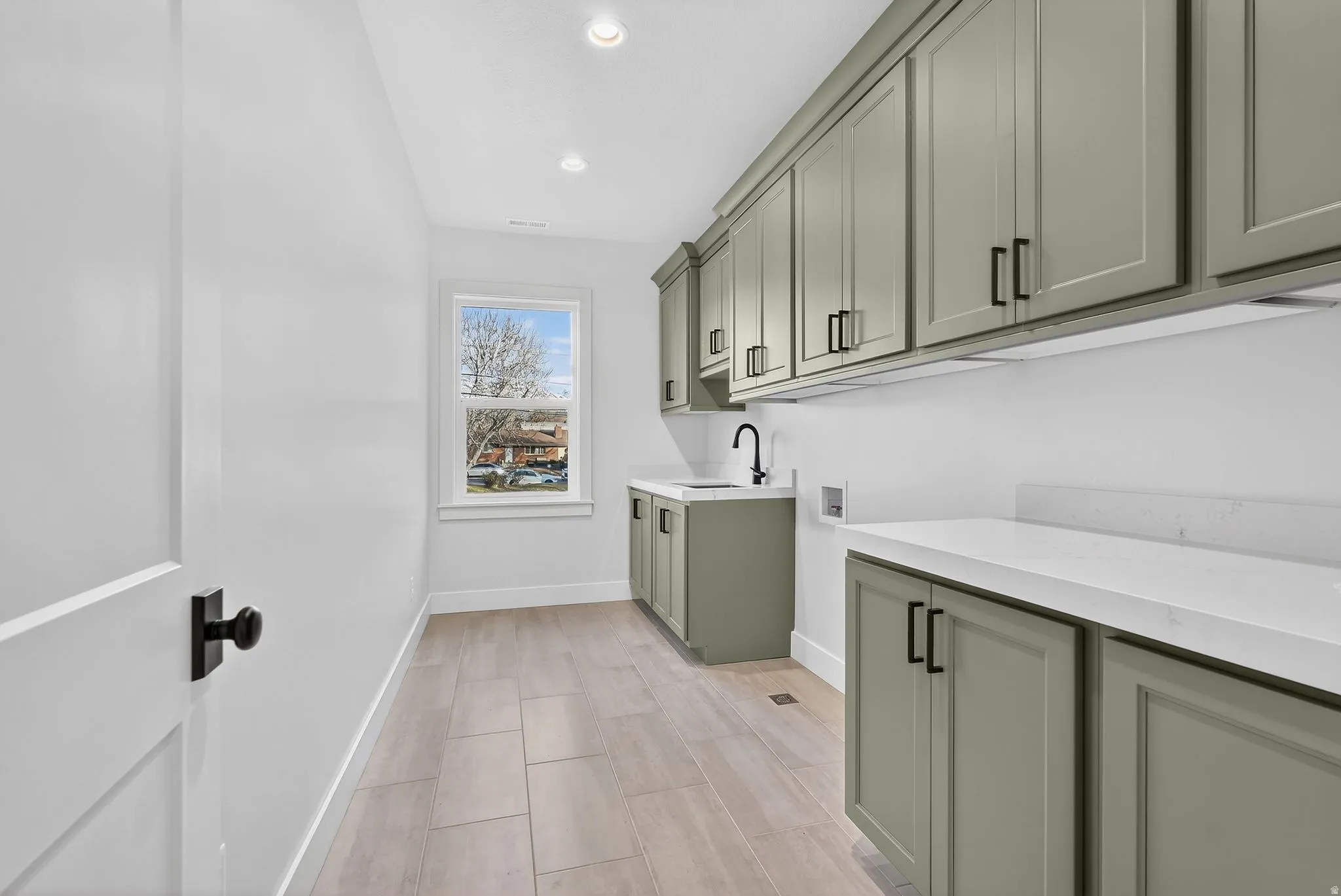 Laundry room and Craft room featuring cabinet space, hookup for a washing machine, and recessed lighting.