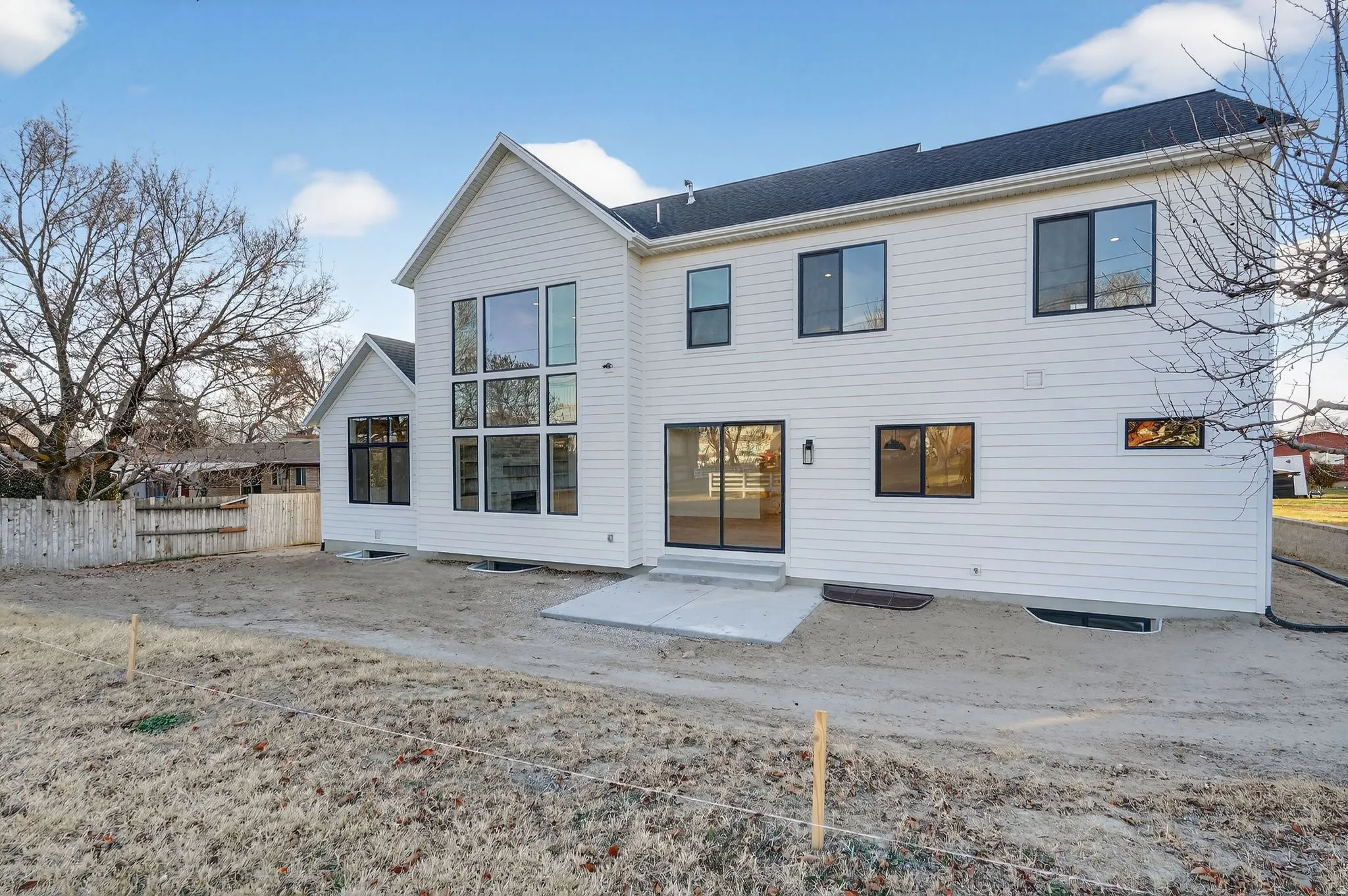Back of property featuring a patio area and roof with shingles