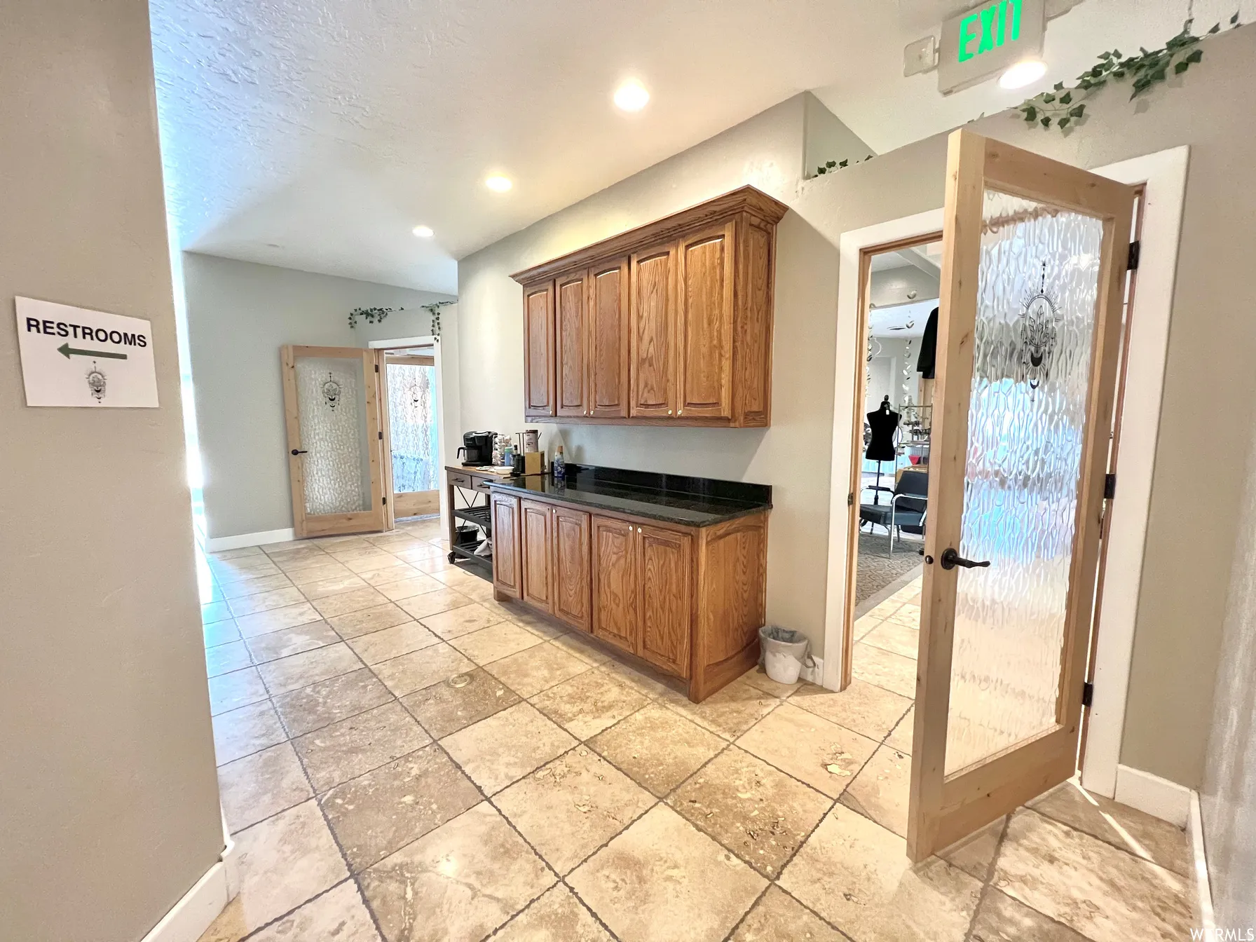 Kitchen featuring brown cabinetry and a textured ceiling