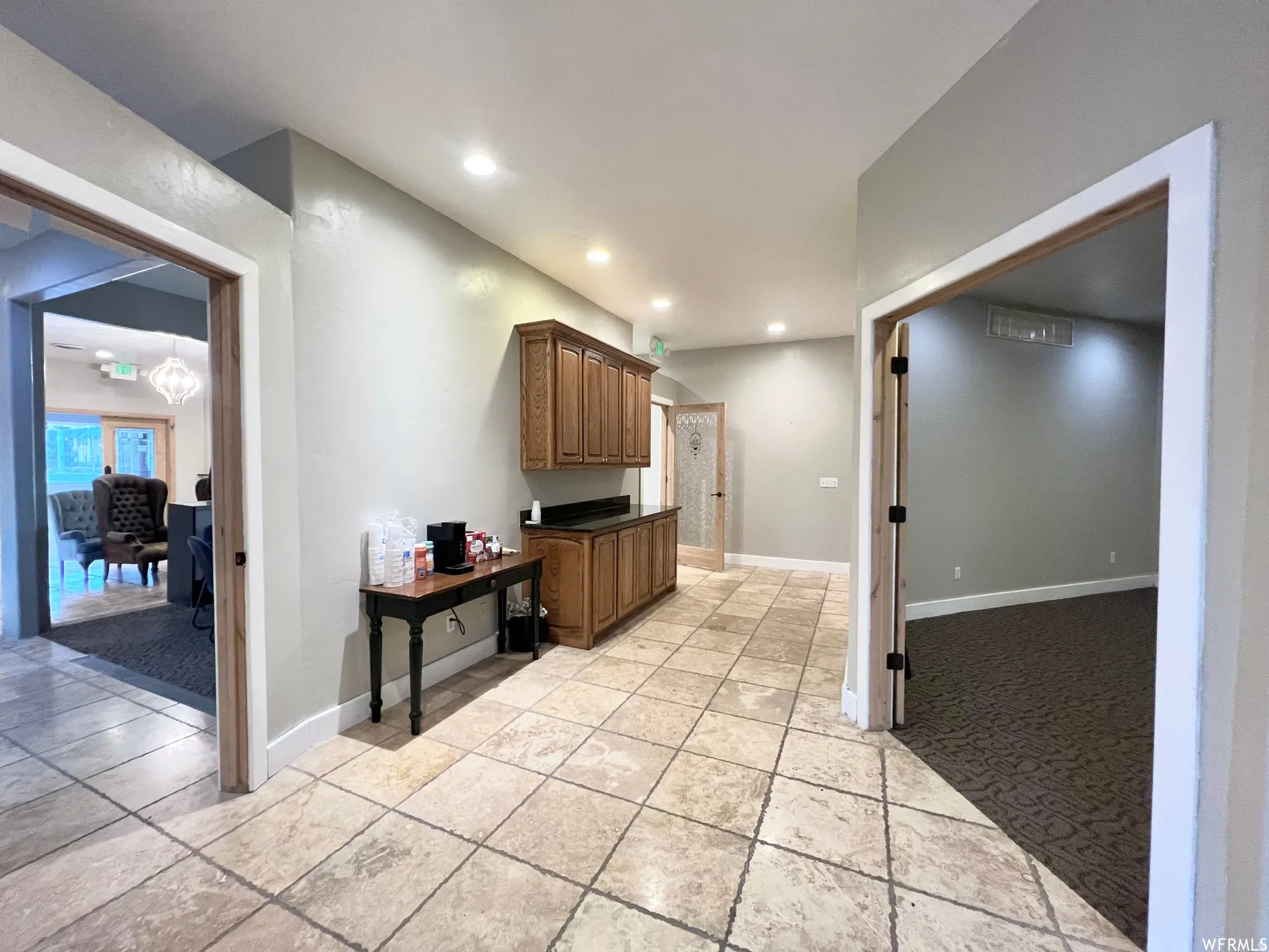 Kitchen featuring light carpet, dark countertops, and recessed lighting