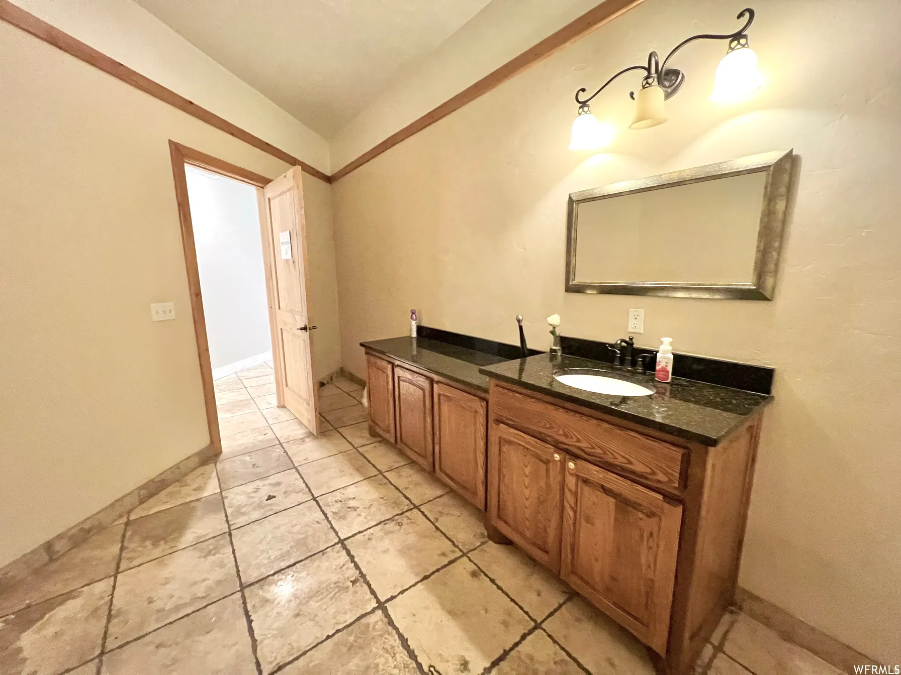 Bathroom featuring vanity and baseboards
