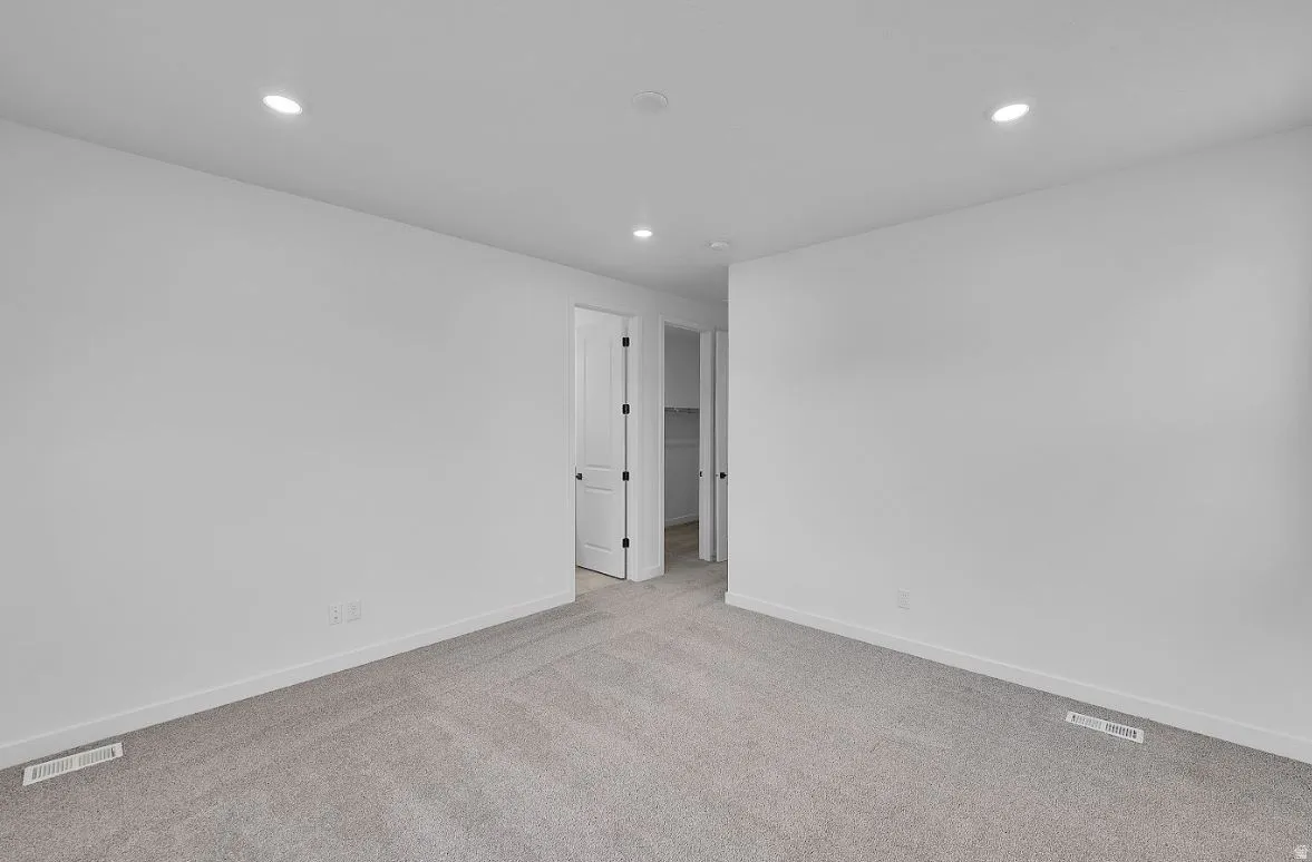 Unfurnished room featuring carpet and recessed lighting