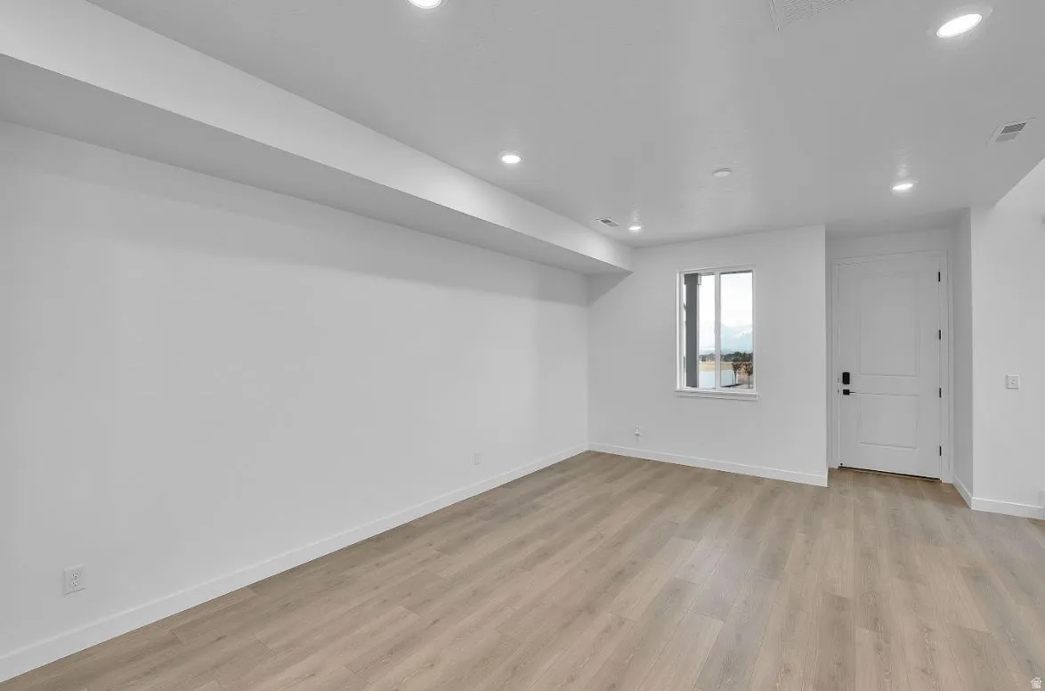 Unfurnished room with light wood finished floors and recessed lighting