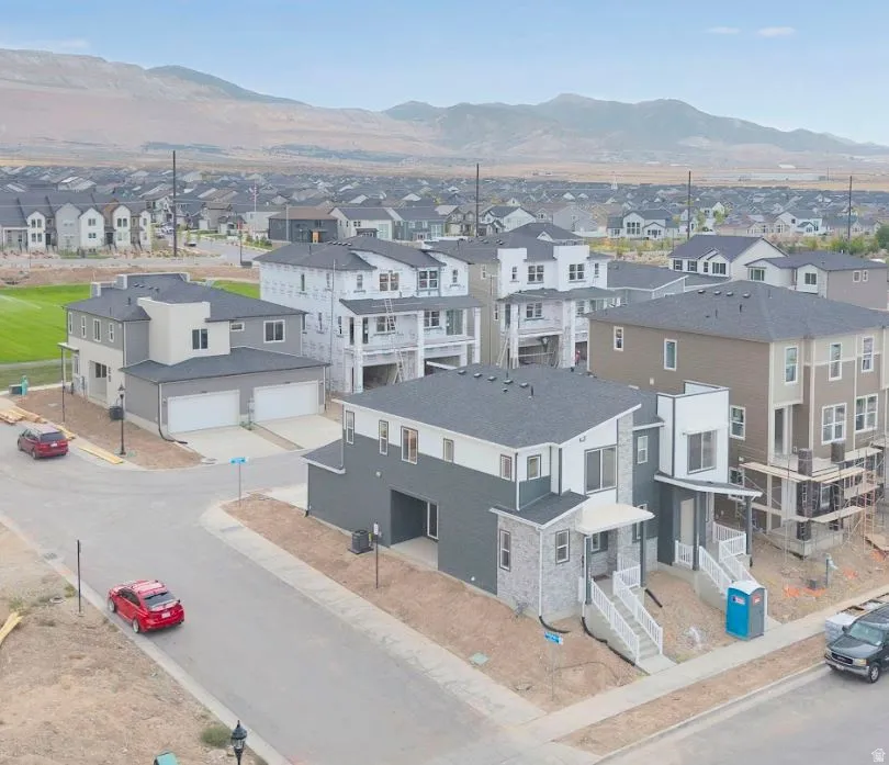 Aerial perspective of suburban area featuring a mountainous background
