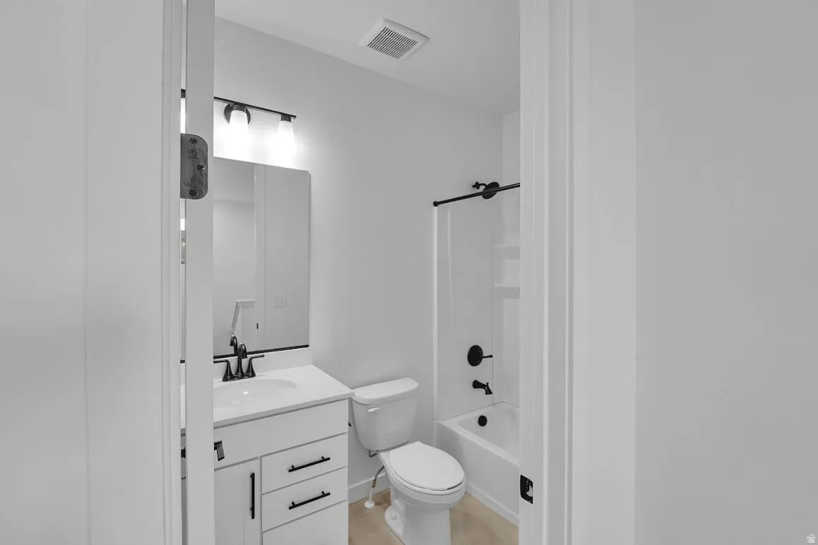 Full bath featuring vanity and shower / washtub combination