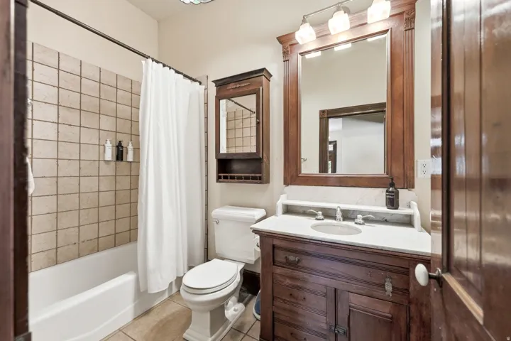 Bathroom featuring a wood vanity with an integrated sink and light-toned countertop