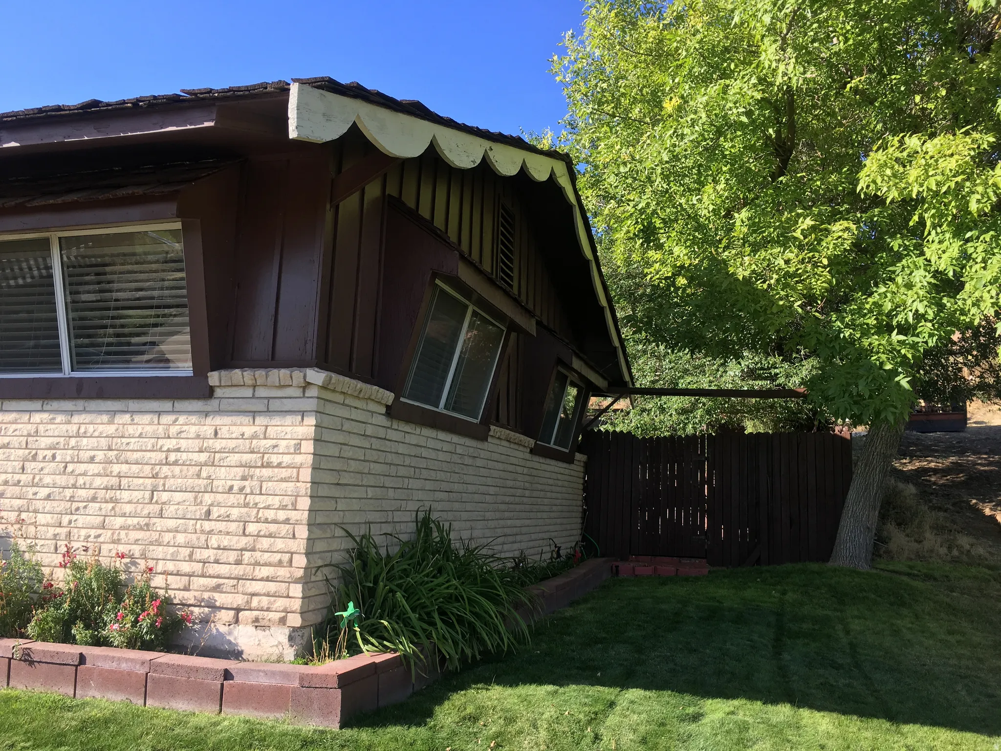 View of side of property featuring brick siding and board and batten siding