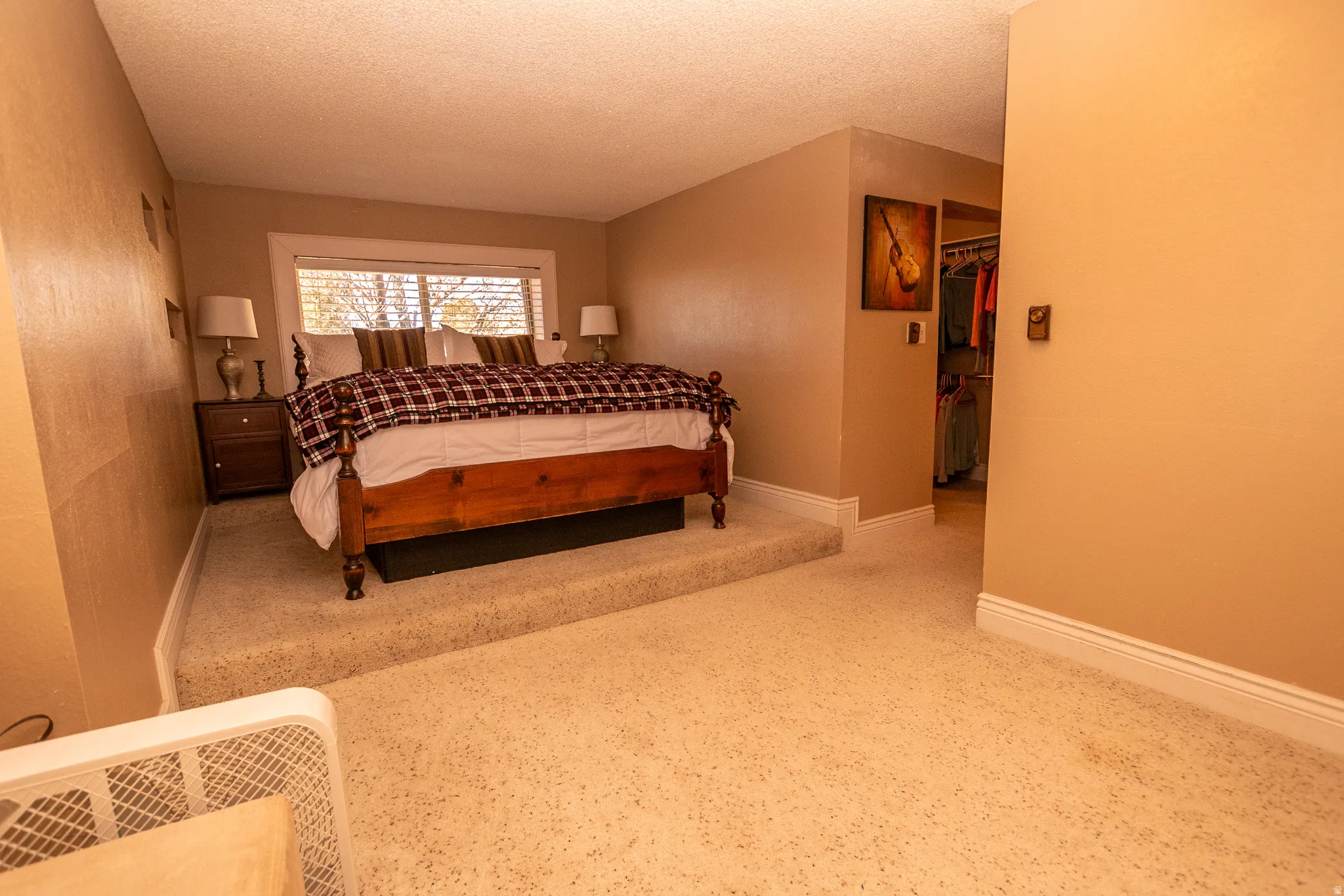 Bedroom with a spacious closet and a textured ceiling