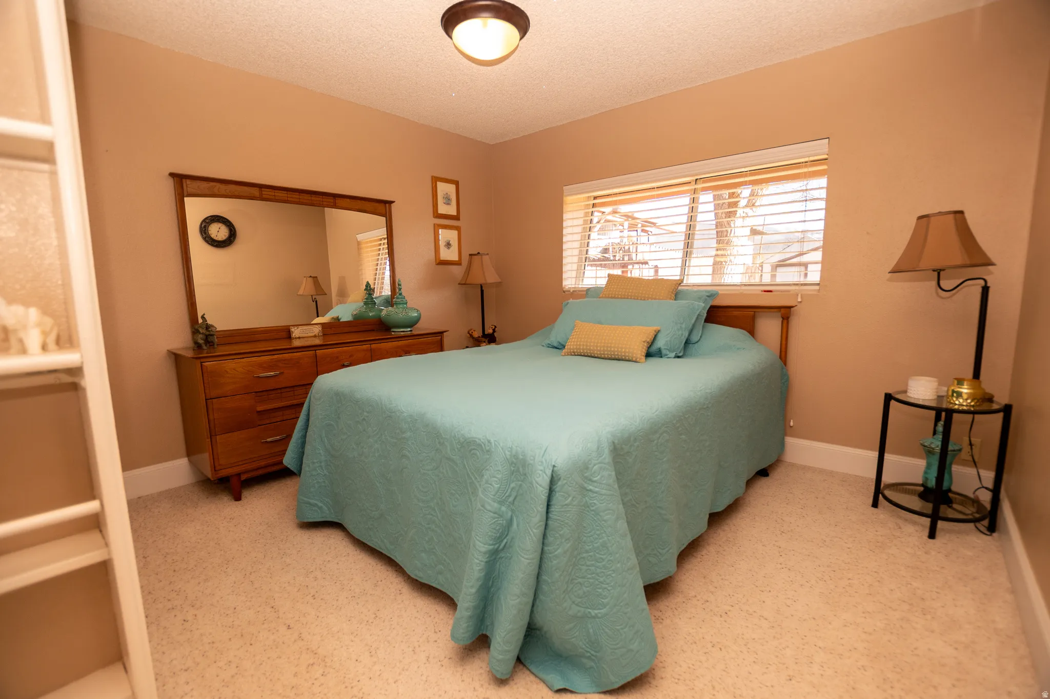 Bedroom featuring a textured ceiling and baseboards